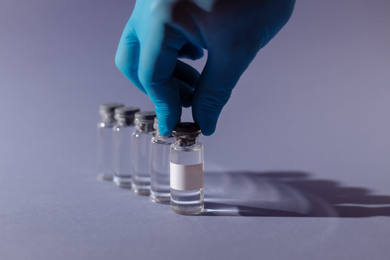 A lab technician handling a peptide vial